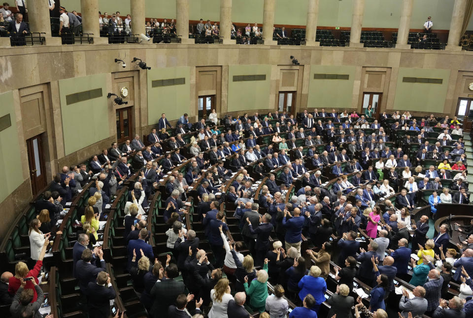 Poland's lawmakers vote in parliament, in Warsaw, Poland, Friday, May 26, 2023. Poland's lawmakers have approved a contentious law targeting the opposition. Critics say the law approved Friday violates a number of provisions in Poland's constitution and is a clear example of how the right-wing ruling party is using the law to its own ends. (AP Photo/Czarek Sokolowski)