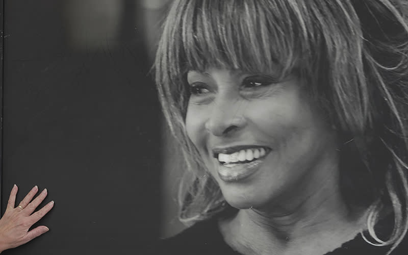 A fan touches the poster featuring Tina Turner