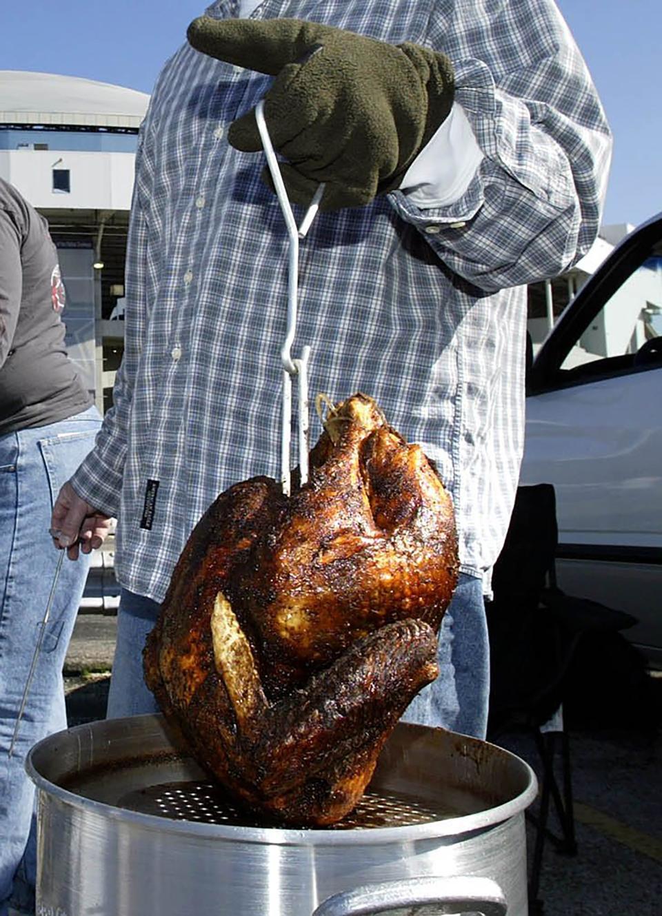 Frying a turkey requires heavy clothing to protect against oil spatter.