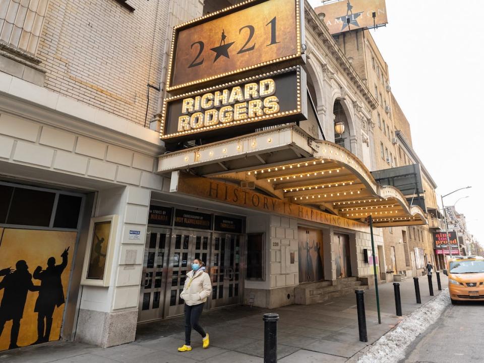 A person walks outside Hamilton at Richard Rodgers Theatre in Times Square in December.