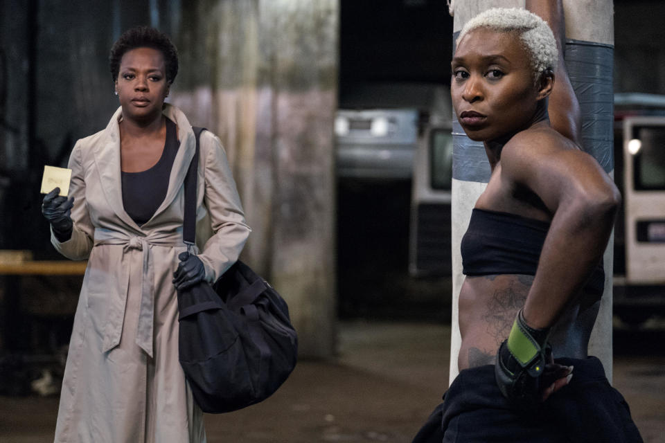 A pair of women look concerned in an empty warehouse