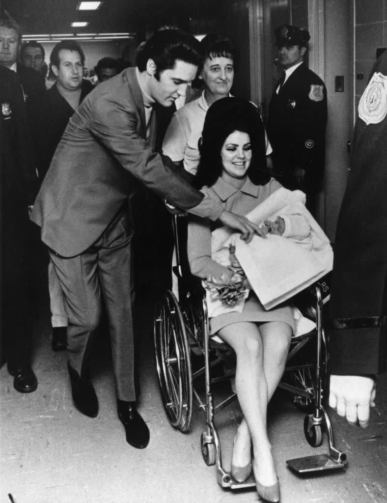 Elvis Presley and Priscilla leaving the hospital with their daughter Lisa-Marie, born on Feb. 2, 1968 in Memphis, Tennessee. 