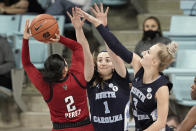 North Carolina State guard Raina Perez (2) shoots while North Carolina guard Alyssa Ustby (1) and guard Petra Holesinska (2) defend during the second half of an NCAA college basketball game in Chapel Hill, N.C., Sunday, Feb. 7, 2021. (AP Photo/Gerry Broome)