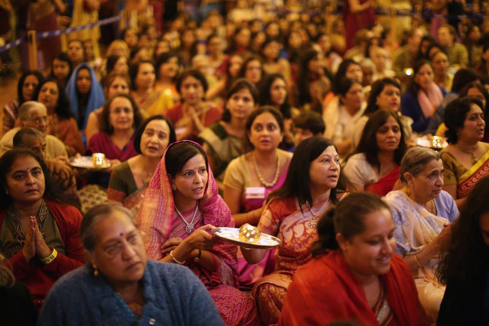 LONDON, ENGLAND - NOVEMBER 14: Scented candles are held by wellwishers during a ceremony as Sadhus and Hindus celebrate Diwali at the BAPS Shri Swaminarayan Mandir on November 14, 2011 in London, England. Diwali, which marks the start of the Hindu New Year, is being celebrated by thousands of Hindu men women and children in the Neasden mandir, which was the first traditional Hindu temple to open in Europe. (Photo by Dan Kitwood/Getty Images)