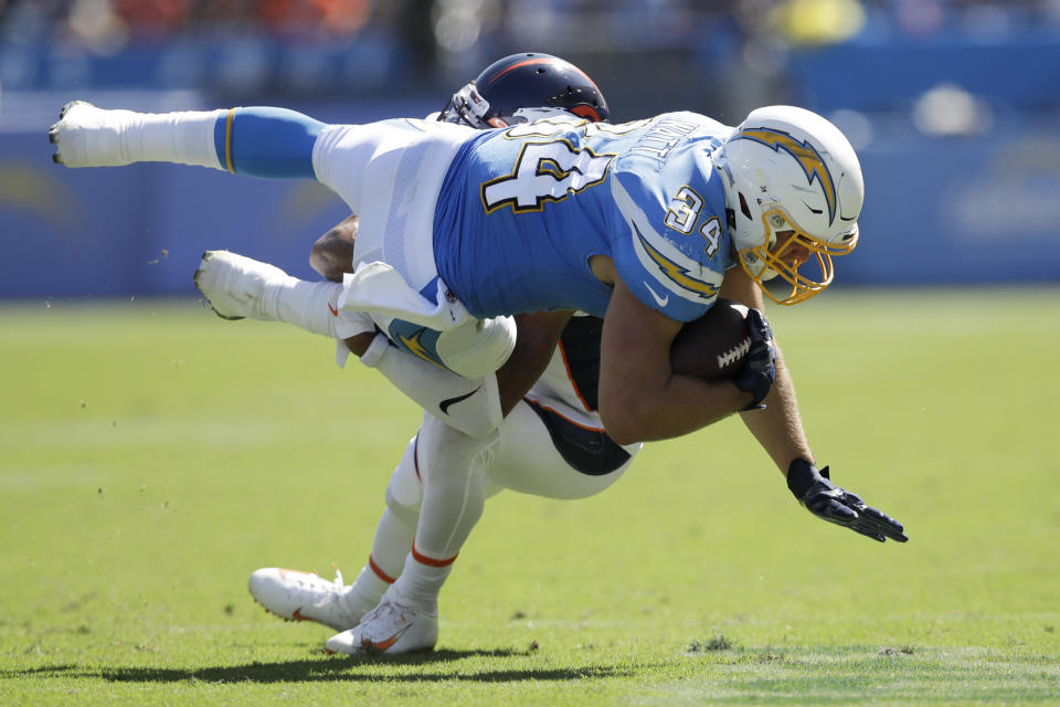 Los Angeles Chargers fullback Derek Watt is tackled by Denver Broncos cornerback Chris Harris during the first half of an NFL football game Sunday, Oct. 6, 2019, in Carson, Calif. (AP Photo/Marcio Jose Sanchez)