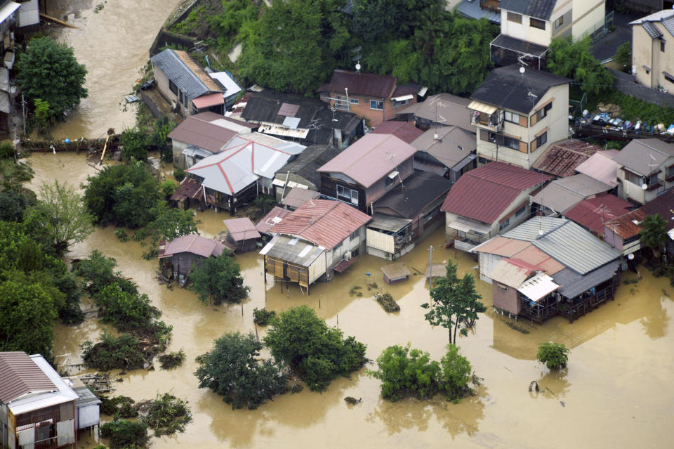 A residential area is submerged by a torrential rain overnight in Kyoto, western Japan, Sunday, July 15, 2012. Heavy rain triggered flash floods in western Japan after days of rains caused heavy damages in southern Japan which killed more than twenty. (AP Photo/Kyodo News) JAPAN OUT, MANDATORY CREDIT, NO LICENSING IN JAPAN, CHINA, HONG KONG, SOUTH KOREA AND FRANCE