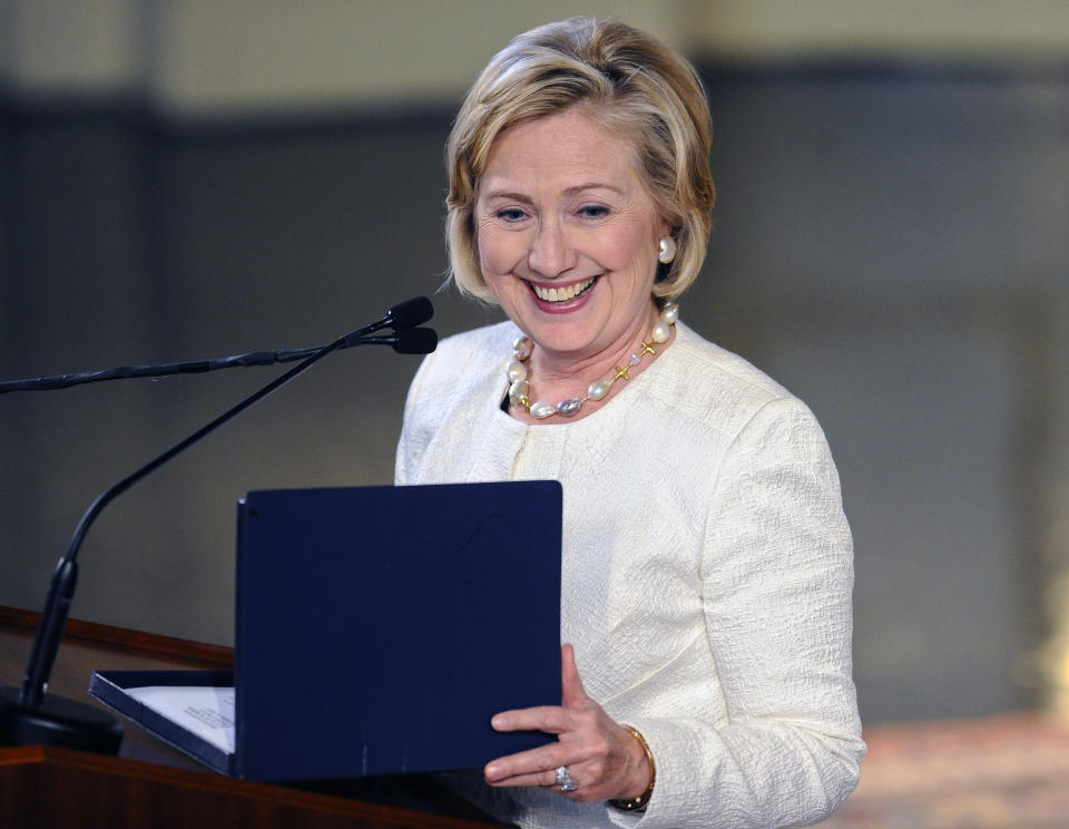 Hillary Clinton greets the audience during a Yale Law School ceremony at Yale University, Saturday, Oct. 5, 2013, in New Haven, Conn. Clinton received the Yale Law School Association Award of Merit, which is presented annually to those who have made a substantial contribution to public service or the legal profession. 