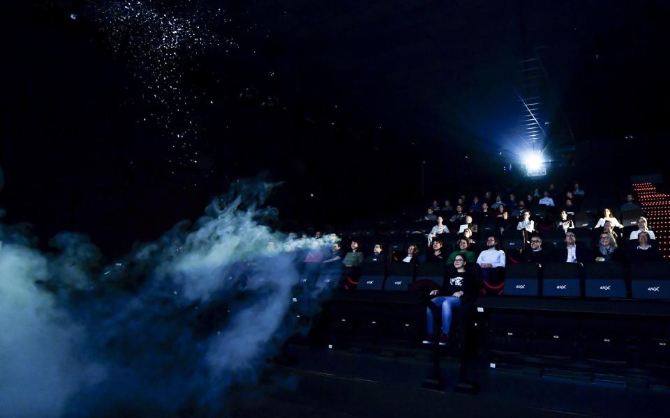 A 4DX audience being sprayed with water