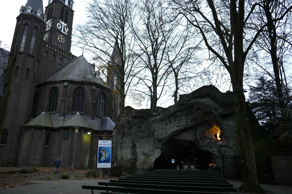 A man walks near a grotto at the church of Sint Willesbrord, Netherlands on Friday, Dec. 1, 2023. In the quiet Dutch village of Sint Willebrord, nearly three out of four voters chose a virulently anti-migrant, anti-Muslim party in an election last year that shattered the Netherlands' image as a welcoming, moderate country. Analysts say far-right parties are primed to gain influence over EU policies affecting everything from civil rights to gender issues to immigration. (AP Photo/Virginia Mayo)