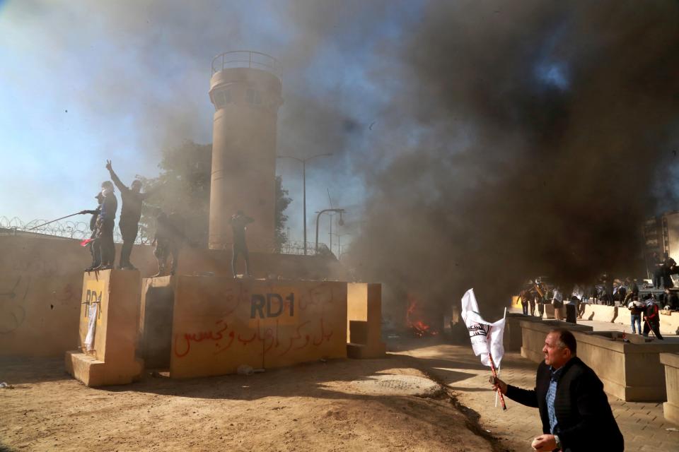 Protesters burn property in front of the U.S. embassy compound, in Baghdad, Iraq, Tuesday, Dec. 31, 2019. (Photo: Khalid Mohammed/AP)