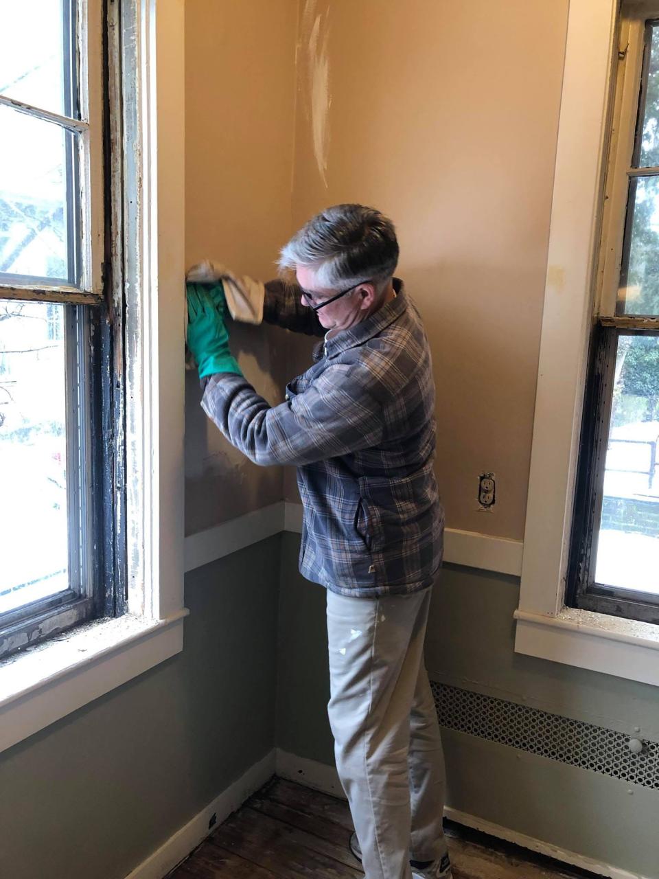 Preservation Society of Fall River board president Jim Soule works on a wall in the Dr. Isaac Fiske House on Pine Street in Fall River in 2019.