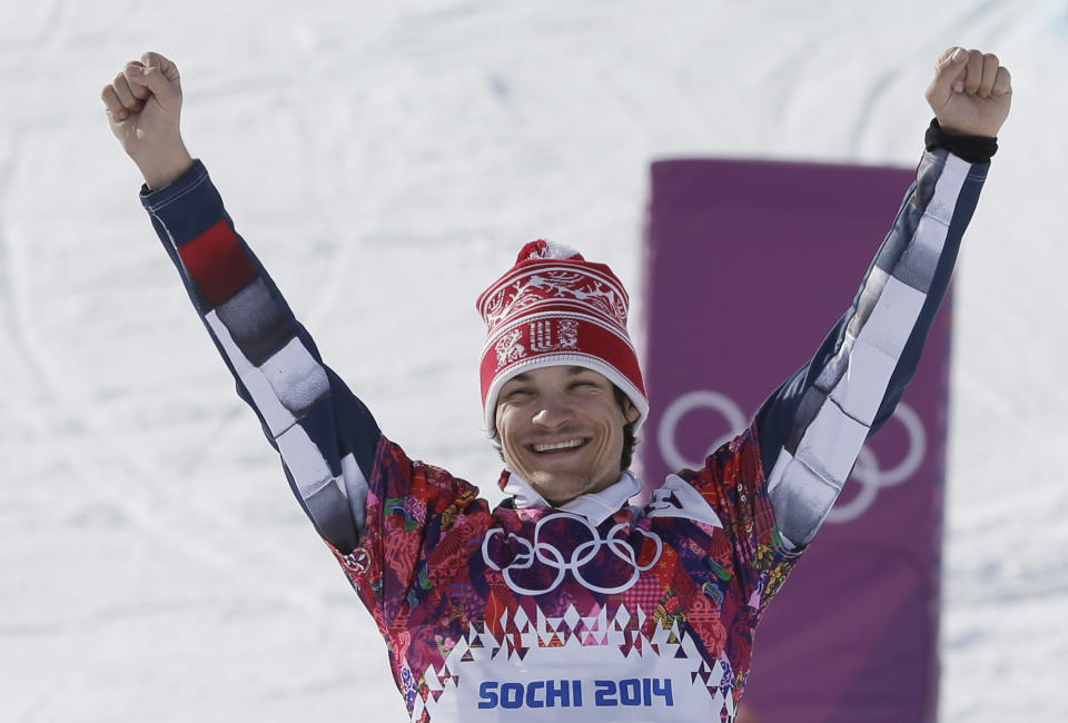 Men's snowboard parallel giant slalom gold medalist Vic Wild of Russia celebrates on the podium at the Rosa Khutor Extreme Park, at the 2014 Winter Olympics, Wednesday, Feb. 19, 2014, in Krasnaya Polyana, Russia. (AP Photo/Andy Wong)