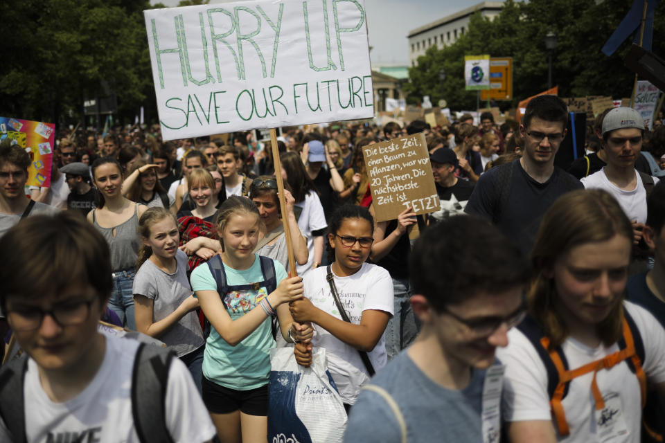 Students hold posters as they attend a protest rally of the 'Friday For Future' movement in Berlin, Germany, Friday, May 24, 2019. The German language poster reads: 'The best time to plant a tree was 20 years ago. The next best time is now'. (AP Photo/Markus Schreiber)