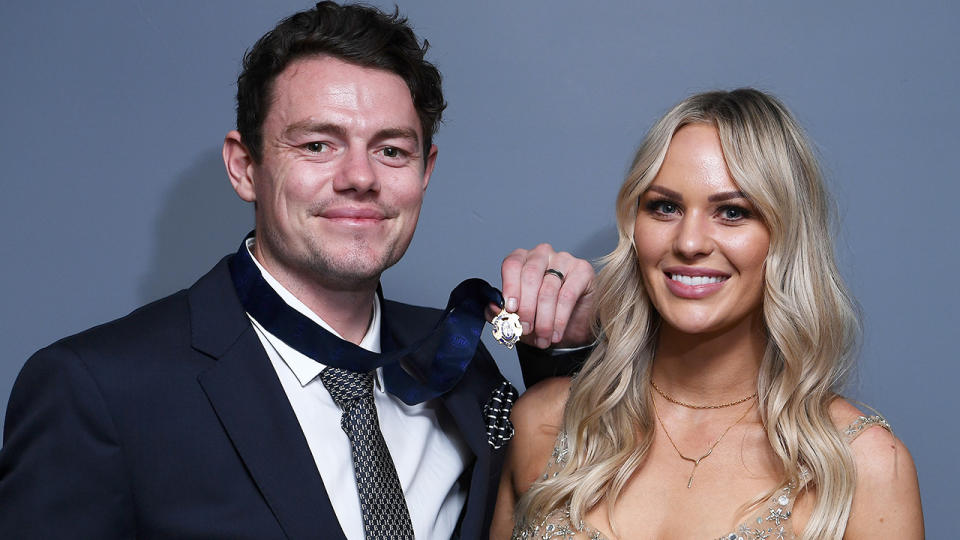 Lachie Neale is pictured with his wife Julie after winning the 2020 Brownlow Medal.