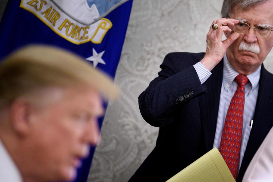 National Security Adviser John Bolton listens while U.S. President Donald Trump speaks to the press before a meeting with Hungary's Prime Minister Viktor Orban.