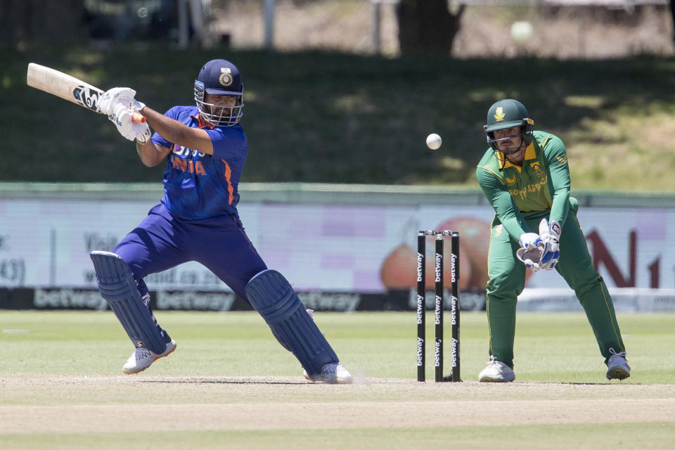 Indian batsman Rishabh Pant plays a shot while South African wicketkeeper Quinton De Kock looks on, during the second ODI match between South Africa and India in Paarl, South Africa, Friday, Jan. 21, 2022. (AP Photo/Halden Krog)