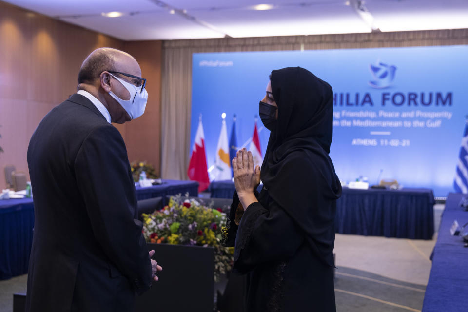 Bahrain's Foreign Minister Abdullatif Al-Zayani, left, speaks with Reem Ebrahim Al-Hashimi, Emirati Minister of State for International Cooperation during a meeting, in Athens, on Thursday, Feb. 11, 2021. Foreign ministers and senior officials from several Persian Gulf countries met in Athens, as Greece seeks to expand alliances to counter tension with regional rival Turkey. (AP Photo/Petros Giannakouris, Pool)