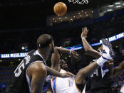 Oklahoma City Thunder guard Reggie Jackson (15) loses the ball and falls after being fouled by Sacramento Kings center DeMarcus Cousins (15) in the third quarter of an NBA basketball game in Oklahoma City, Sunday, Jan. 19, 2014. Oklahoma City won 108-93. (AP Photo/Sue Ogrocki)