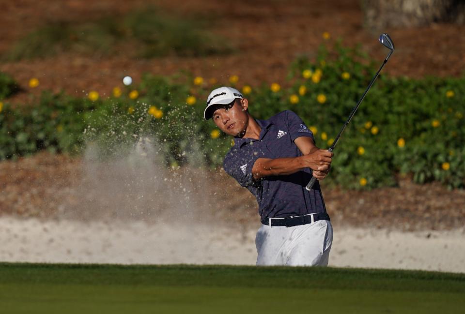 Collin Morikawa hits out of a bunker on the 14th hole during the first round of The Players Championship golf tournament at TPC Sawgrass Stadium Course in 2021.