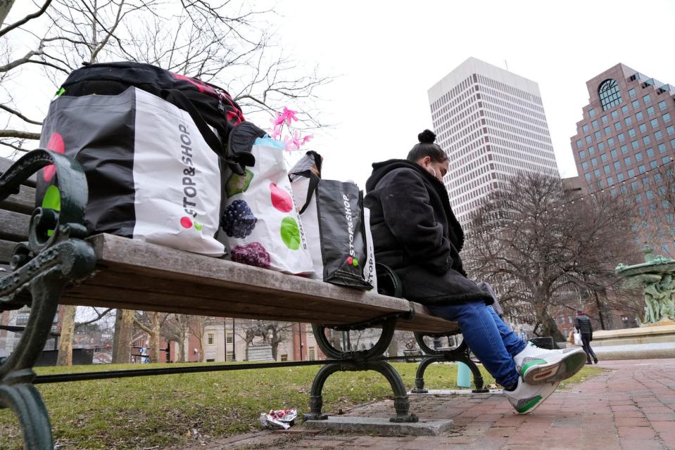 Shanelle Saraceno, six months pregnant and living on the streets, sits among grocery bags containing her and her boyfriend's possessions on a bench in Providence's Burnside Park.