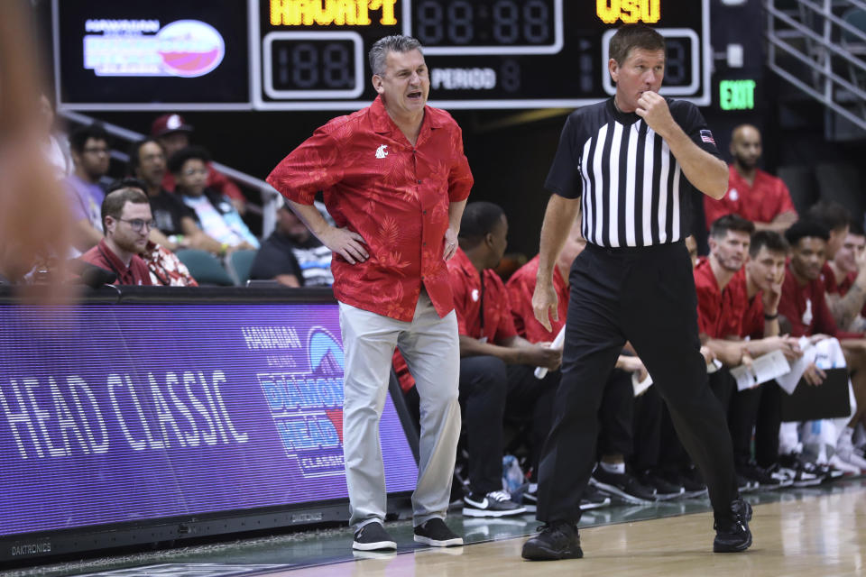 Washington State coach Kyle Smith watches the team play against Hawaii during the first half of an NCAA college basketball game Friday, Dec. 23, 2022, in Honolulu. (AP Photo/Marco Garcia)