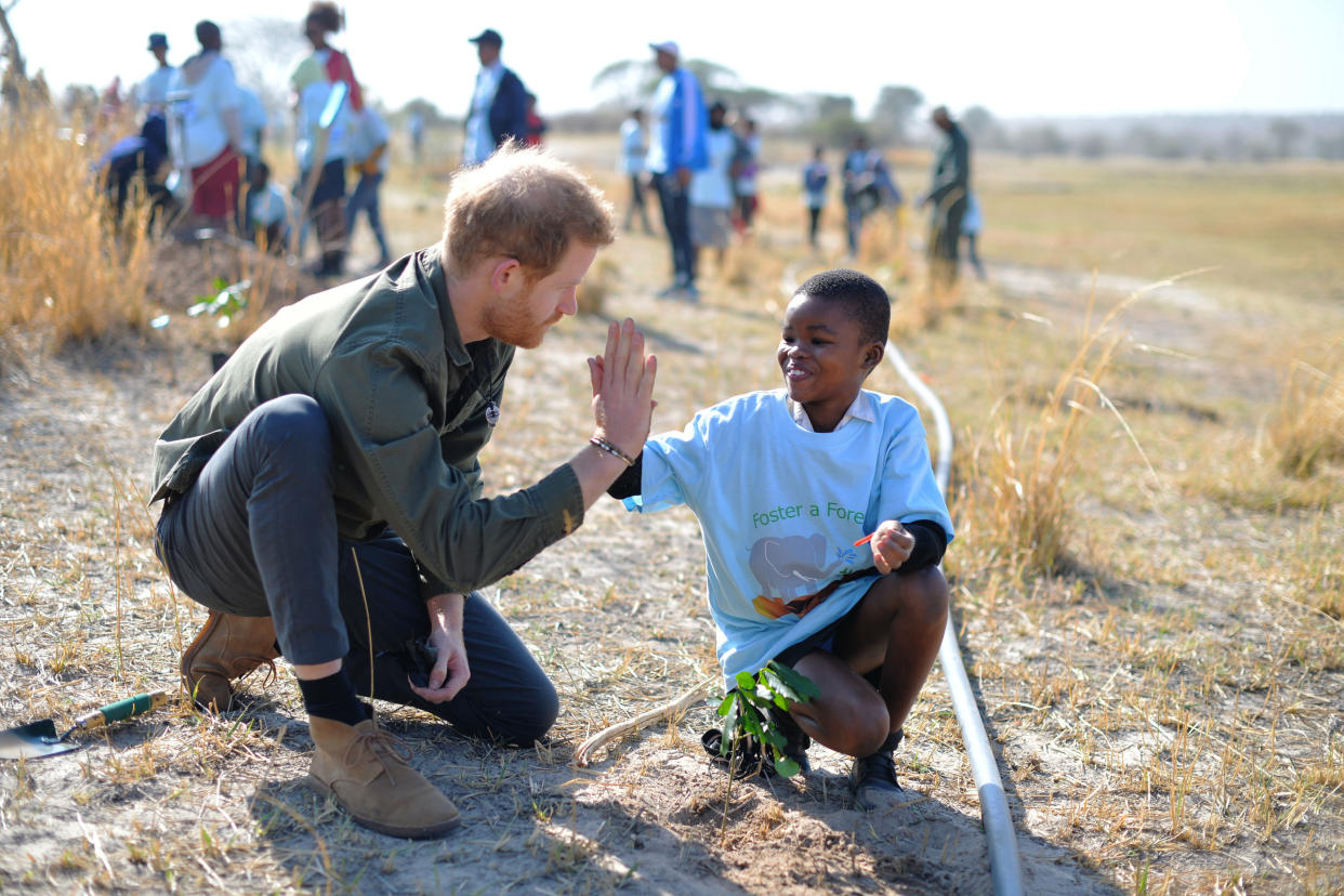 Prince Harry, Duke of Sussex, helps local schoolchildren plant trees at the Chobe Tree Reserve in Botswana, on day four of their tour of Africa on September 26, 2019 in Chobe National Park, Botswana.