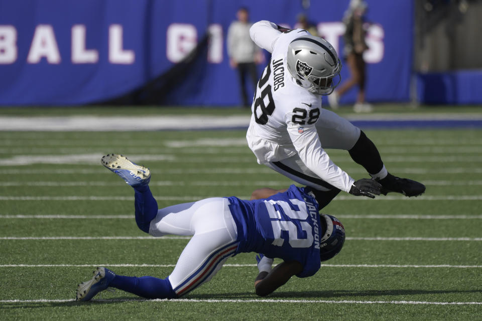 New York Giants' Adoree' Jackson (22) tackles Las Vegas Raiders' Josh Jacobs (28) during the first half of an NFL football game, Sunday, Nov. 7, 2021, in East Rutherford, N.J. (AP Photo/Bill Kostroun)