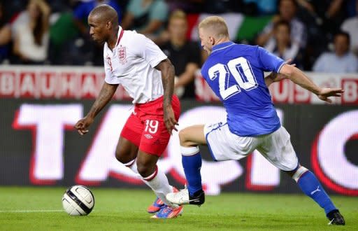 English forward Jermain Defoe (L) dodges Italian defender Ignazio Abate during a friendly football match on August 15, 2012 in the Swiss capital Bern. England pulled off their first victory over Italy in 15 years, winning 2-0