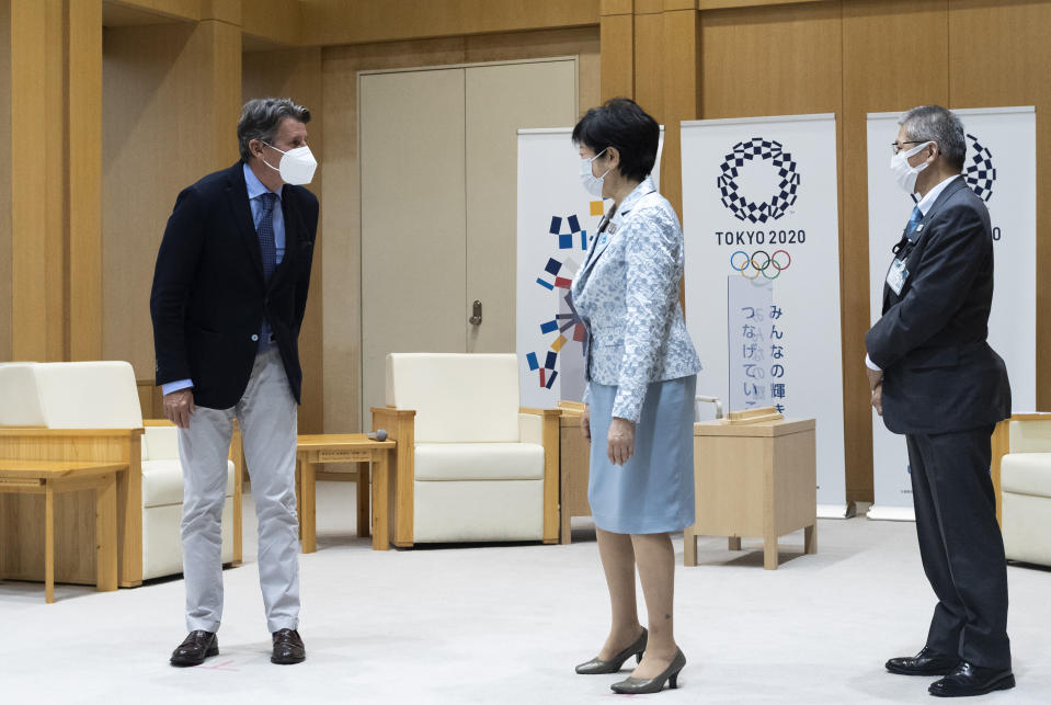 Sebastian Coe, left, the president of World Athletics, an internationally governing organization for the sport of athletics, greets Tokyo Gov. Yuriko Koike before they have a talk in Tokyo on Friday, May 7, 2021. Seiko Hashimoto, the president of the Tokyo Olympic organizing committee, said Friday IOC President Thomas Bach to make a planned visit this month to Japan with a state of emergency order being extended by the government until May 31 to Tokyo and other areas. (AP Photo/Hiro Komae)