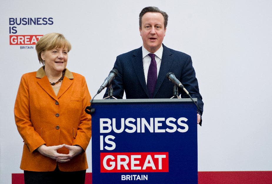 German Chancellor Angela Merkel listens to British Prime Minister David Cameron, right, as he speaks during their opening tour across the computer fair CeBIT in Hannover, Germany, Monday March 10, 2014. (AP Photo/dpa,Christoph Schmidt)