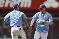 Kansas City Royals second baseman Nicky Lopez (8) and right fielder Whit Merrifield (15) celebrate their win over the Boston Red Sox in a baseball game at Kauffman Stadium in Kansas City, Mo., Sunday, June 20, 2021. (AP Photo/Colin E. Braley)