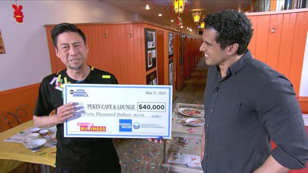 PHOTO: Jerry Tam holds up a $40,000 check from American Express. (ABC News)