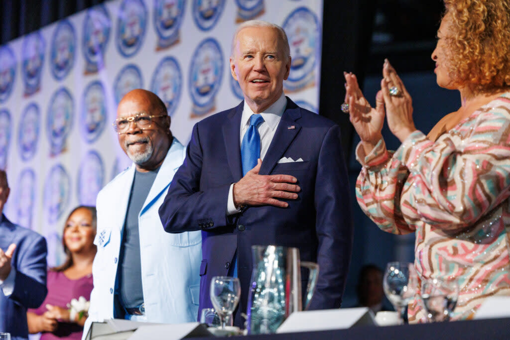 President Joe Biden on stage with several people