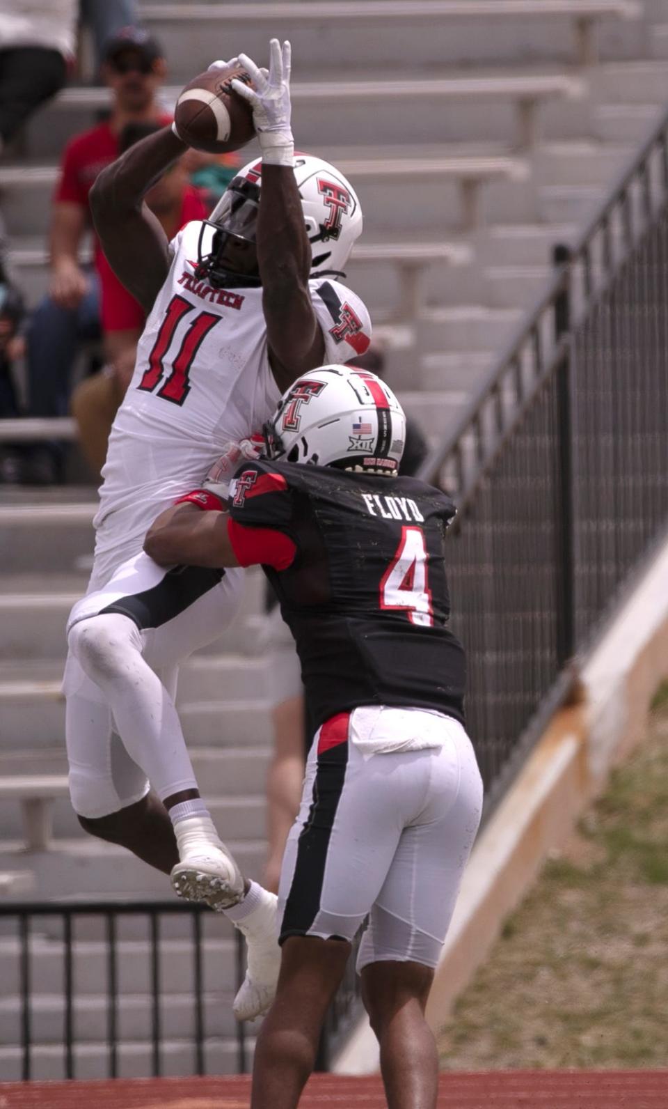 Texas Tech wide receiver Loic Fouonji (11) makes a catch over defensive back Nate Floyd (4) during the Red Raiders' annual spring game Saturday at PlainsCapital Park/Lowrey Field. Fouonji finished with three catches for a game-high 103 yards, including a 58-yard touchdown.