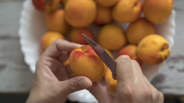 slicing peach with paring knife