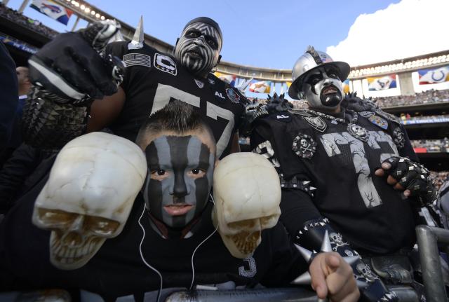 An Oakland Raiders fan is dressed like Santa Claus during the