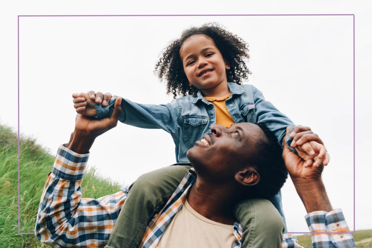  Girl on man's shoulder holding hands. 