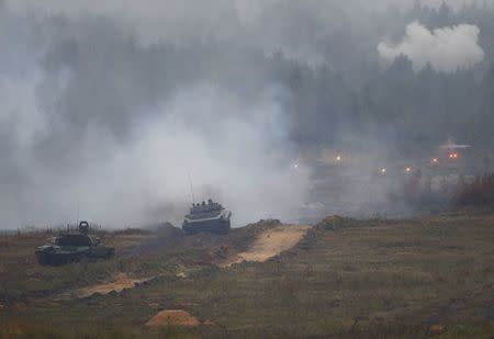 A tank and an armoured vehicle take part in the Zapad 2017 war games at a range near the town of Borisov, Belarus September 20, 2017. REUTERS/Vasily Fedosenko