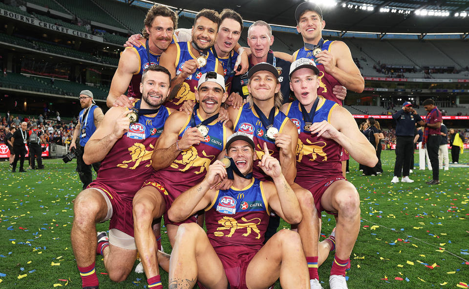 Joe Daniher and Eric Hipwood with Brisbane Lions teammates.