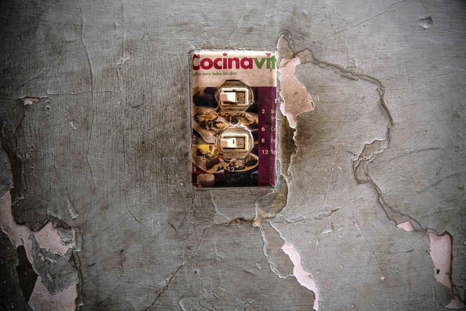 A makeshift light switch plate is decorated with an image of baked goods in the home of Yuliet Colon, a 39-year-old mother of two and a contributor to the Facebook page, ”Recipes from the Heart," in Havana, Cuba, Friday, April 2, 2021. (AP Photo/Ramon Espinosa)