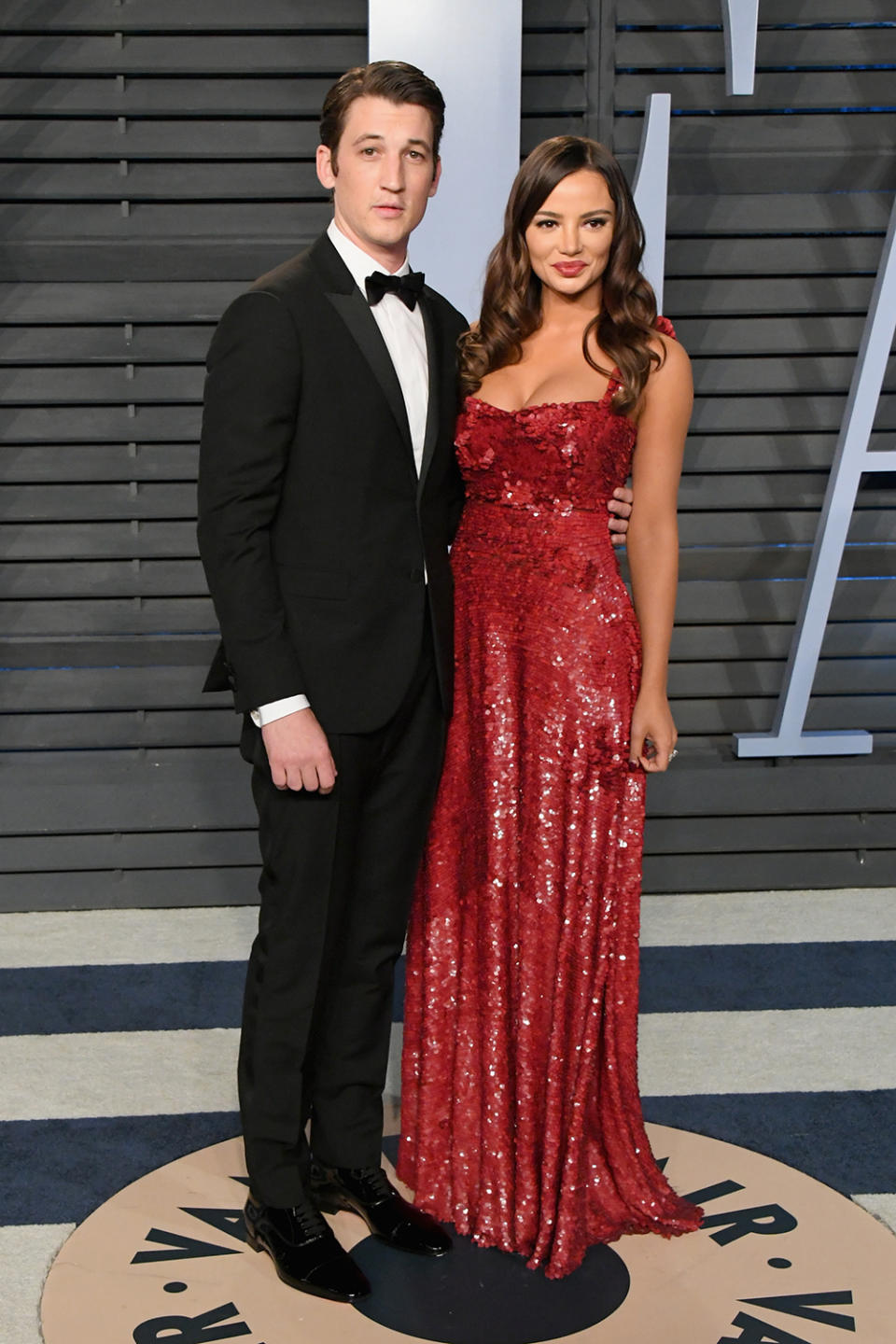 <p>Newly engaged Miles Teller and Keleigh Sperry made a handsome pair at <em>Vanity Fair</em>. (Photo: Jon Kopaloff/WireImage) </p>