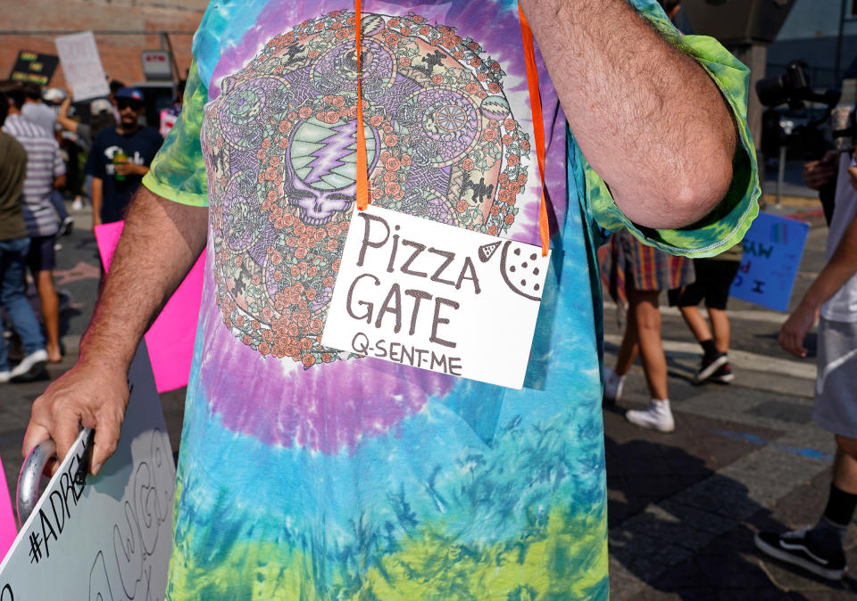 A protester with a Pizzagate and QAnon sign at a Save Our Children rally in Los Angeles, Aug. 22, 2020.<span class="copyright">Jamie Lee Curtis Taete</span>