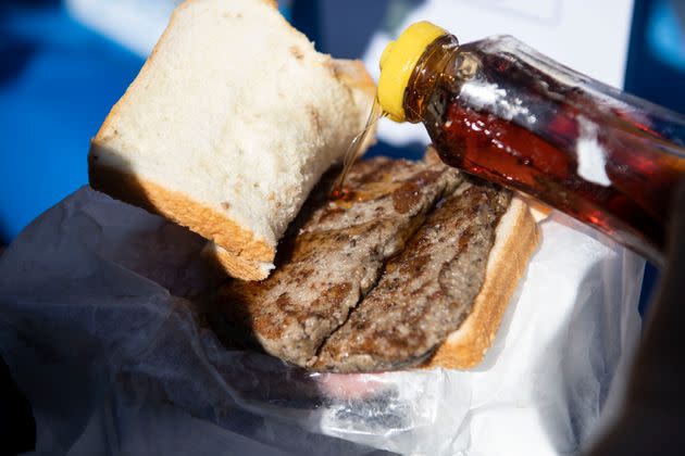 The famous scrapple sandwich. Here, a person puts syrup on their scrapple. (Photo: Damon Dahlen/HuffPost)