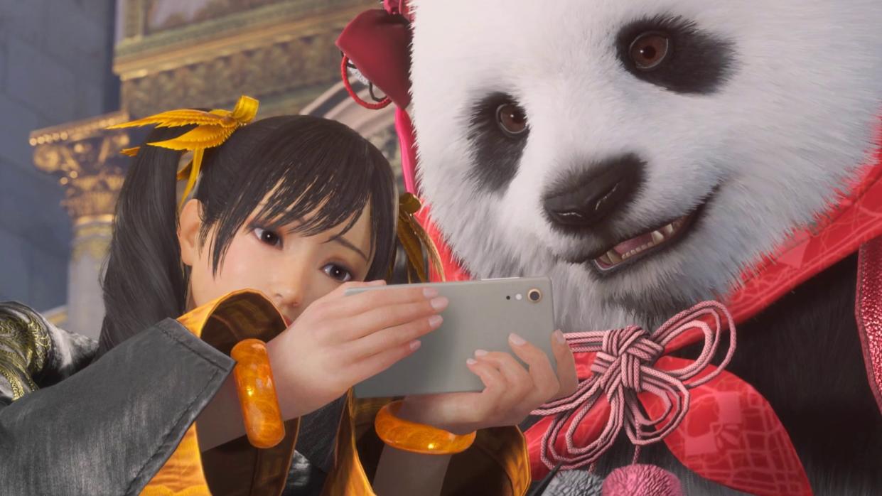 A panda watches video on a smartphone. 