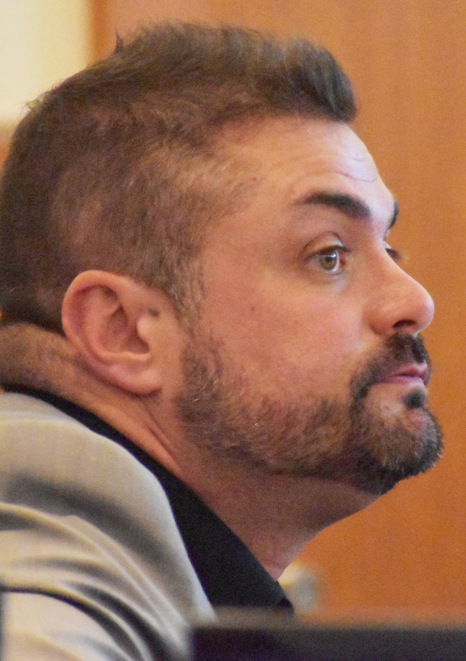 Former Fall River police officer Michael Pessoa listens to the proceedings of his trial in court on Tuesday, May 23.