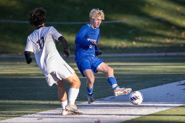 Douglas’s Liam Deplaise attempts to pass against Westport's Will Quinlan in the D5 state soccer final on Saturday November 18, 2023 at Doyle Field in Leominster.