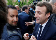 Emmanuel Macron (R), head of the political movement En Marche !, or Onwards !, and candidate for the 2017 presidential election, flanked by Alexandre Benalla (L), head of security, attends a campaign visit in Rodez, France, May 5, 2017. Picture taken May 5, 2017 . REUTERS/Regis Duvignau