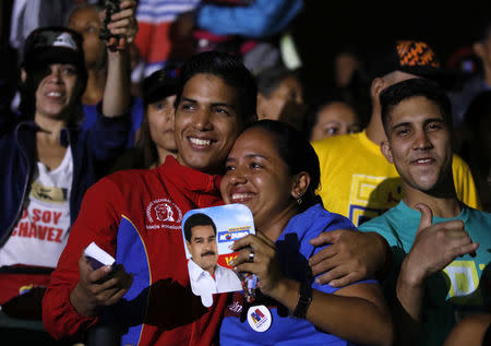 Supporters of Venezuela's President Nicolas Maduro celebrate the results of the election, outside of Miraflores Palace in Caracas, Venezuela, May 20, 2018. REUTERS/Carlos Garcia Rawlins