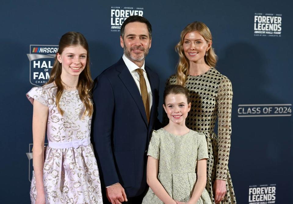 NASCAR Hall of Fame member Jimmie Johnson, center, poses with his wife Chandra Janway, right, and daughters Genevieve, left, and Lydia, right, on the red carpet at the NASCAR Hall of Fame in Charlotte, NC, on Friday, January 19, 2024.