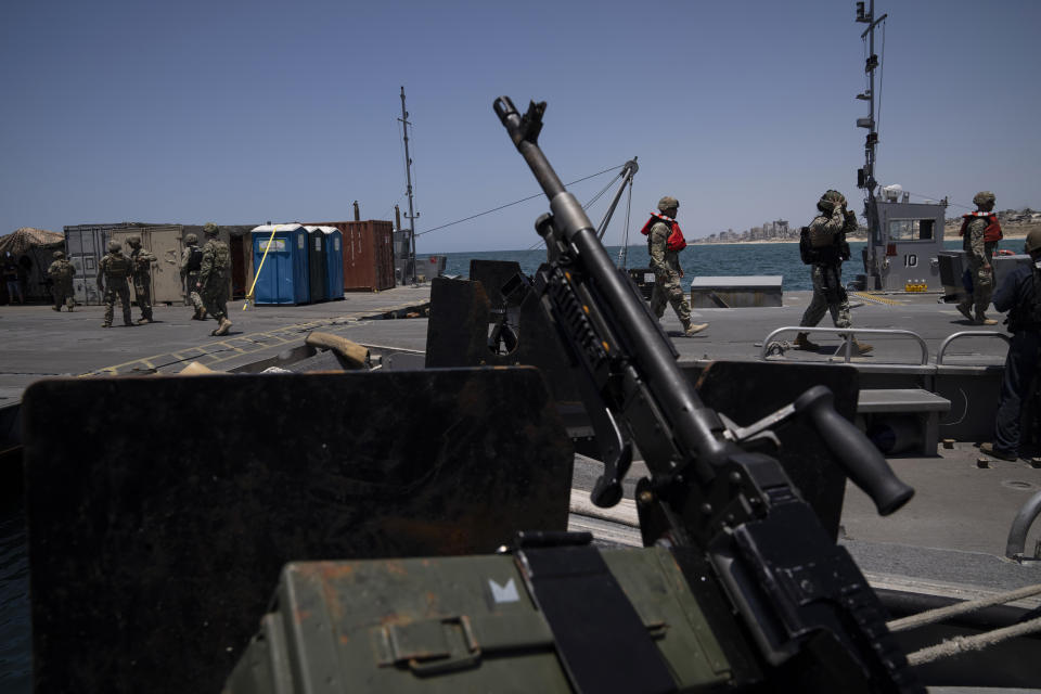 U.S. Army soldiers stand at the U.S.-built floating pier Trident backdropped by the coast of the Gaza Strip, Tuesday, June 25, 2024. (AP Photo/Leo Correa)
